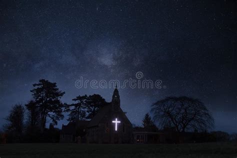 An Atmospheric Concept Edit Of A Church With A Glowing Cross Below A