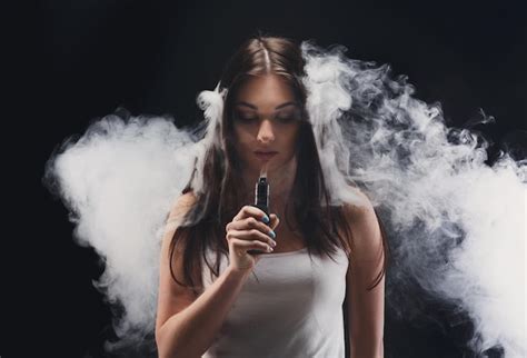 Premium Photo Young Woman In A Cloud Of Vape Smoke Studio Shot