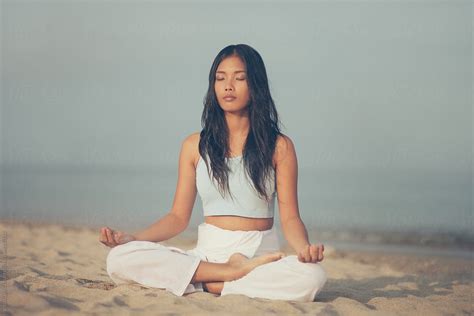 Asian Woman Meditating On Beach Del Colaborador De Stocksy Visualspectrum Stocksy
