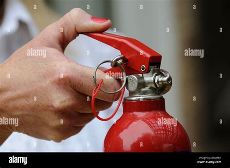 Metal Safety Pin In Place On A Fire Extinguisher Stock Photo Alamy
