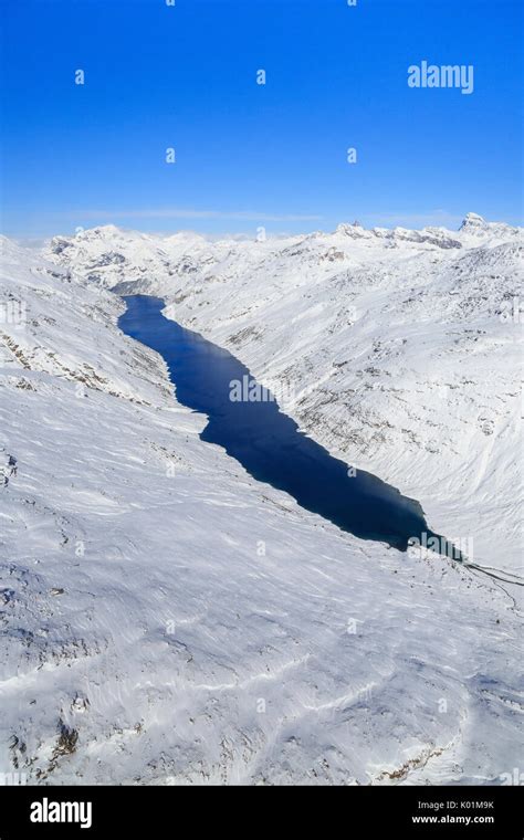 Aerial View Of The Alpine Lago Di Lei Surrounded By Snow Val Di Lei