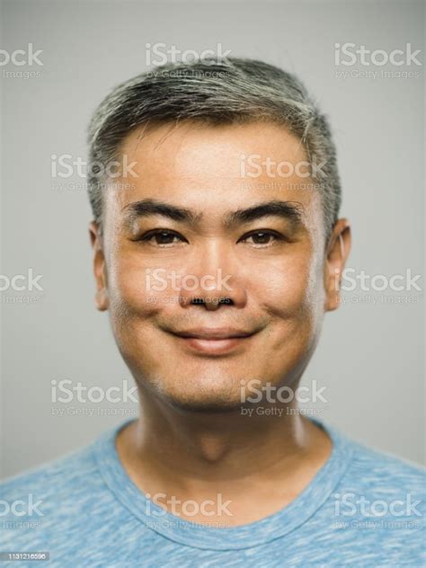 Portrait Of Real Chinese Mature Man With Happy Expression Looking At