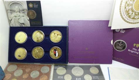 A Collection Of Commemorative Coin Sets Including Four £5 Coins A 2002