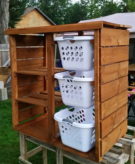 Three White Laundry Baskets Stacked On Top Of Each Other In Front Of A