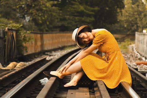 Woman Sitting On Train Tracks · Free Stock Photo