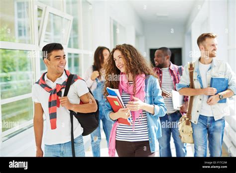 Teenage Couple Talking After Lesson While Walking Along College