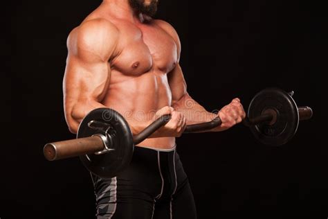 Muscular Male Athlete Is Training By Lifting The Barbell Stock Image