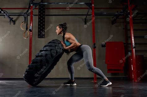 Premium Photo Fit Female Athlete Working Out With A Huge Tire Turning