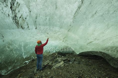 Person Exploring Ice Cave In Glacier Near Kulusuk Sermersooq East