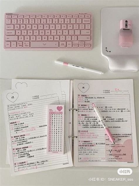 A Pink Keyboard And Some Papers On A Desk