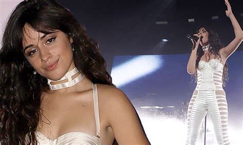 camila cabello flaunts her figure in white lace up jumpsuit with sheer accents at private concert