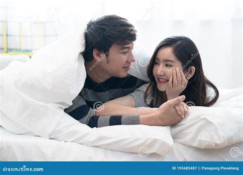 Happy Asia Couple Teasing Each Other On The Bed In The Bedroom Stock Image Image Of Cheerful