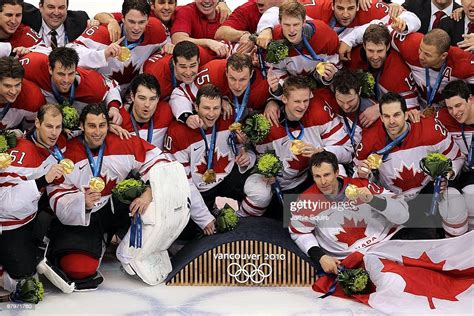 Team Canada Poses For A Team Photo With Their Gold Medals After News