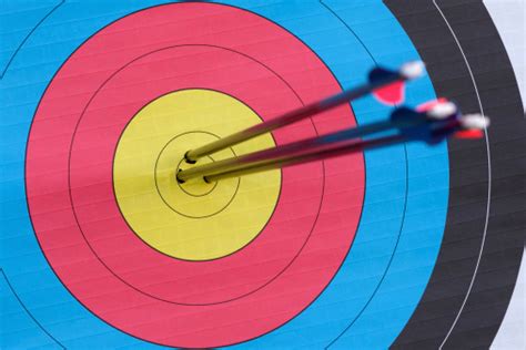 Closeup Of 3 Arrows In The Bullseye Of An Archery Target Stock Photo