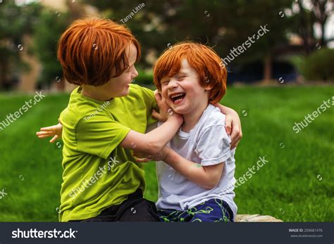 Two Young Brothers Playing Outside Rain Stock Photo 209681476