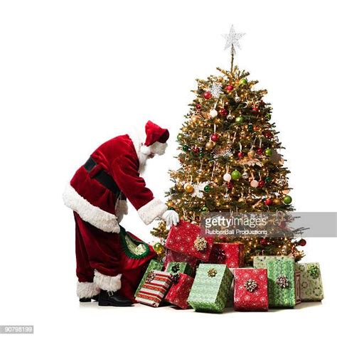 Santa Putting Presents Under Tree Photos And Premium High Res Pictures Getty Images