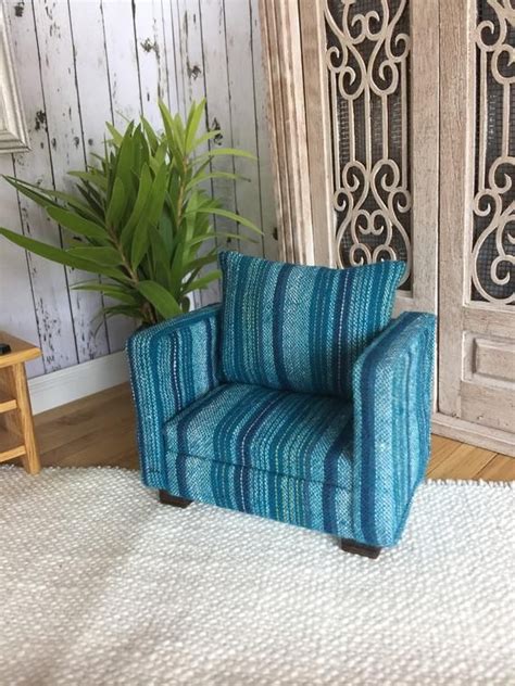 Armchairs, sofa with patterned cushions and wooden wall in a living room interior. Miniature doll house 12th scale Modern wooden framed ...