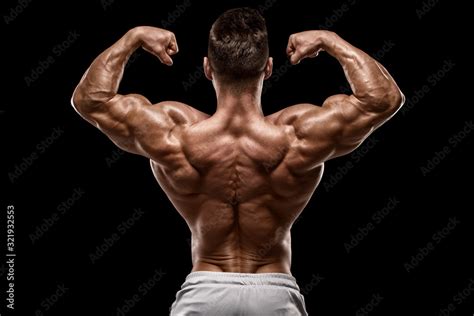 Muscular Man Showing Back Muscles Rear View Isolated On Black