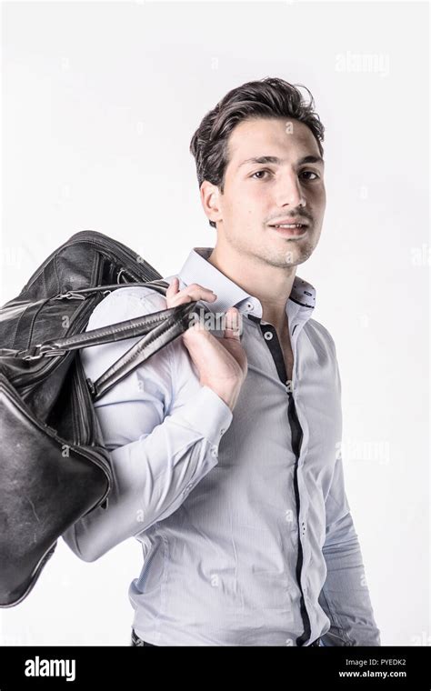 Young Attractive Man On White Background Carrying Big Black Leather Bag