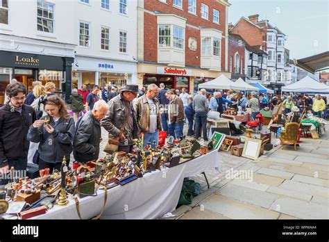 Antiques Displayed For Sale On A Market Stall In The Guildford Antique