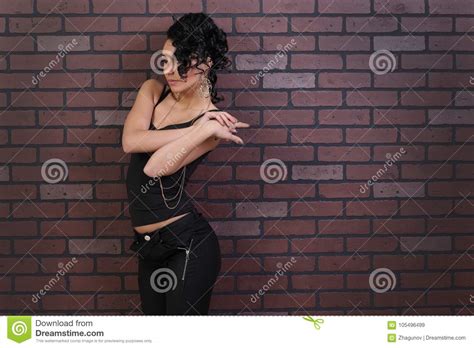 brunette on a background of brick wall stock image image of glamour leather 105496499
