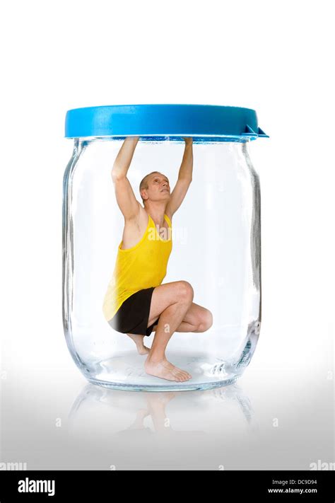 A Man Trapped In A Glass Jar With The Closed Blue Color Lid Stock Photo