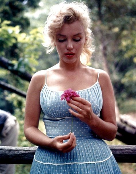 Marilyn Monroe Holding A Red Flower