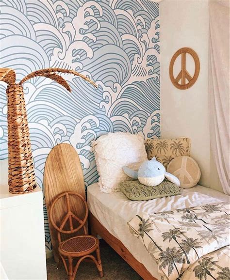 A Small Bed In A Room With A Peace Sign On The Wall And Palm Tree Next