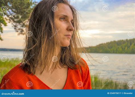 beautiful woman in red dress by lake stock image image of model girl 234975017