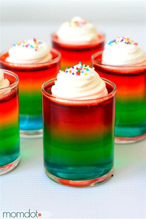 Sized plastic cups arranged on a baking sheet using a measuring cup or mini baster. How To Make Rainbow Jello Shots