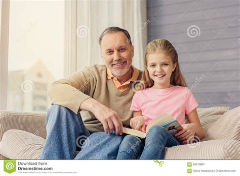 Joyful Grandfather Teaching Granddaughter To Read Stock Image Image
