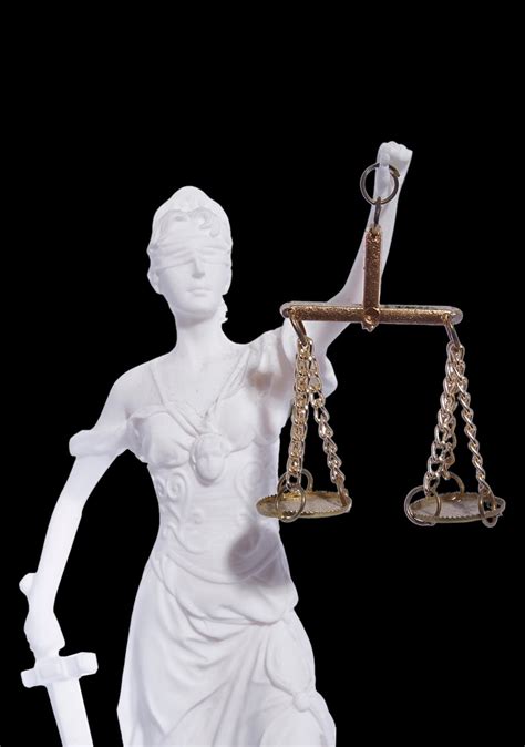 Themis The Greek Goddess Of Justice Holding The Scales Of Justice And