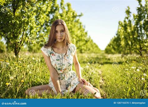 Beauty Girl Is Sitting On The Grass Stock Photo Image Of Hair