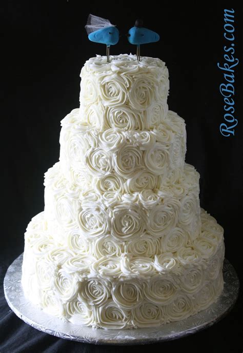 Timeless wedding cake with creamy white patience roses. Buttercream Roses Wedding Cake With Blue Love Birds ...