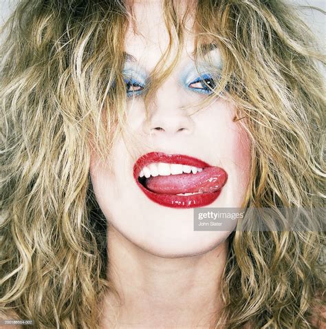 Young Woman Sticking Out Tongue To Side Of Mouth Closeup Portrait