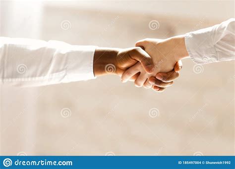 Handshake Between African And A Caucasian Business Man Stock Photo