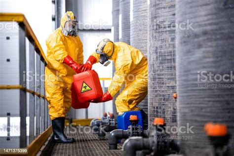 Factory Workers Handling Dangerous Chemicals Or Acids Inside Chemical
