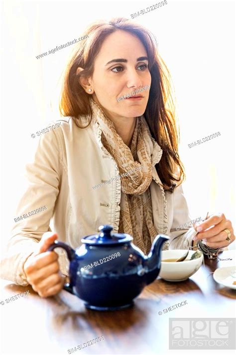 Caucasian Woman Drinking Tea At Table Stock Photo Picture And Royalty