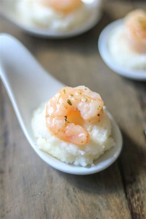 Shrimp On Top Of Mashed Potatoes In A Spoon