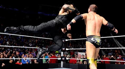 Wwe Roman Reigns Superman Punch On Curtis Axel Wwe Pinterest Wwe