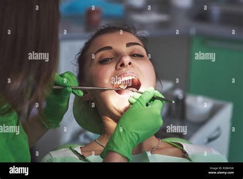 Dentist Curing A Female Patient In The Stomatology Early Prevention And Oral Hygiene Concept