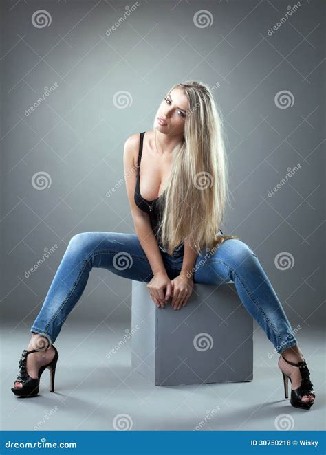 Spectacular Blonde Posing On Cube In Studio Stock Photo Image Of