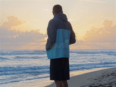 Thoughtful Man Standing Watching The Sunrise On Tropical Beach Stock