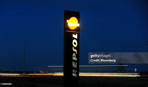 The Logo Of Repsol Ypf Sa Stands On Display Outside A Gas Station On