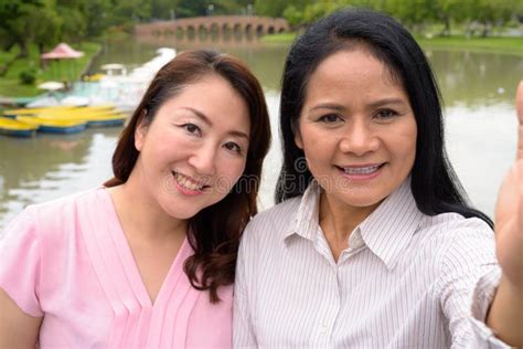 two mature asian women together relaxing at the park stock image image of nature bangkok