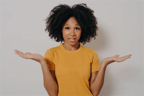 Confused Doubtful Black Woman Shrugging With Shoulders Feeling Baffled While Looking At Camera