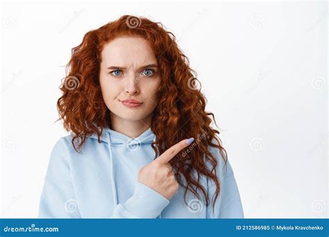 Disappointed Frowning Redhead Woman Pointing Finger Right At Something