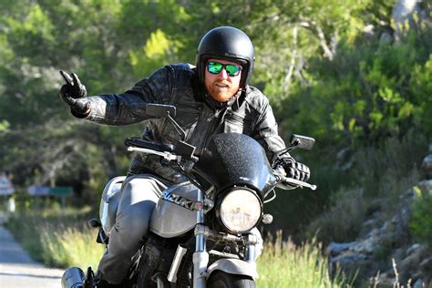 Man Riding A Motorcycle Doing A Peace Sign · Free Stock Photo