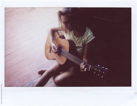 Beautiful Woman Playing The Guitar On The Floor By Stocksy