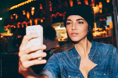 Girl Taking Selfie In Pub By Stocksy Contributor Guille Faingold Stocksy